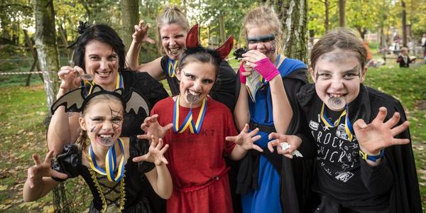 deelnemers met hun medaille van de Halloween Survival Run
